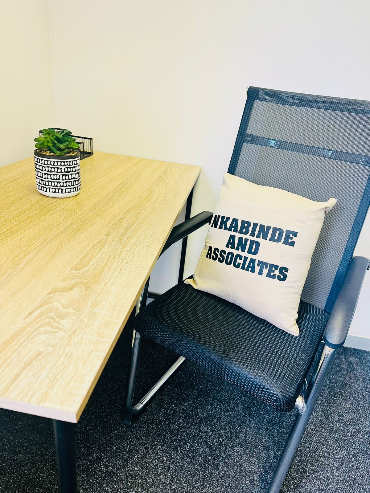 Nkabinde and Associates office — consultation chair with branded cushion
